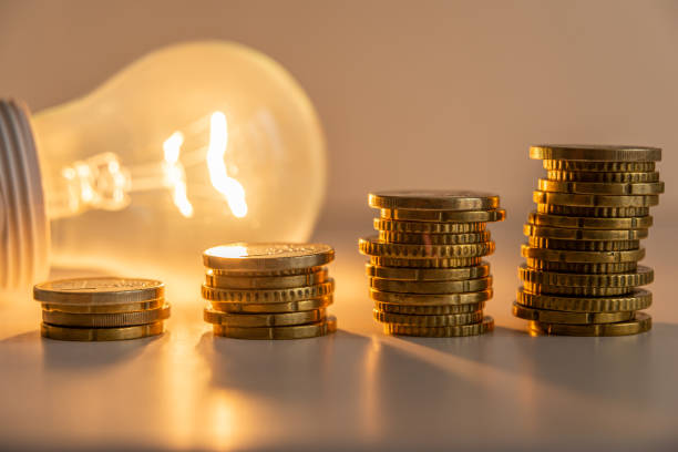 Image of coins with a lightbulb as lighting.