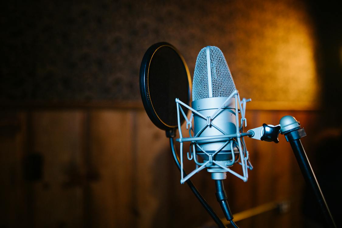 Image of a microphone on a recording studio.